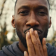 Cameron kissing his wife's fingertips in a moment of happiness.